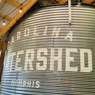 a large metal tank with a sign that reads