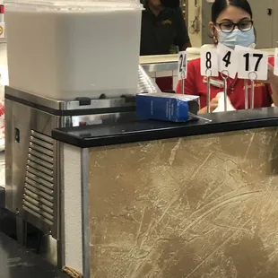 Employee in back handling food without mask or gloves