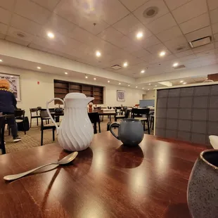 a wooden table with a white pitcher on it