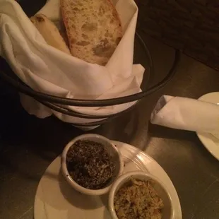 Complementary breadbasket served with black and green olive tapenades