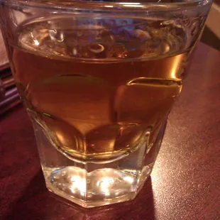 a glass of whiskey on a table