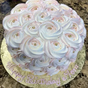 a cake decorated with pink and white roses