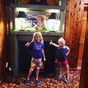 two little girls in front of a fish tank