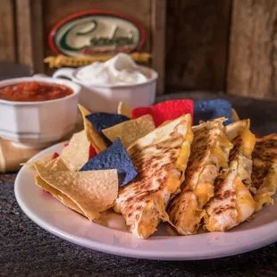 a plate of quesadillas and chips