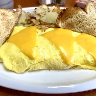 Corned beef hash omelette home fries and toast.