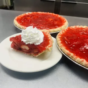 two pies with whipped cream on top