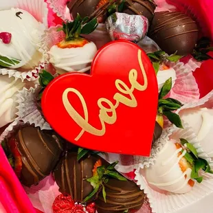 a heart shaped box of chocolate covered strawberries