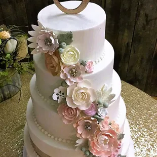 a wedding cake decorated with flowers