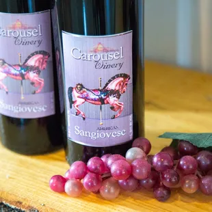 two bottles of wine and grapes