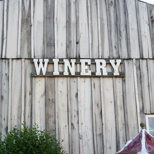 a carousel in front of a wooden building