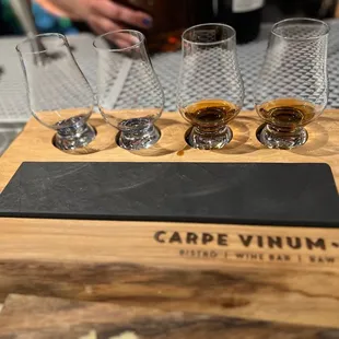 four glasses and a slate board