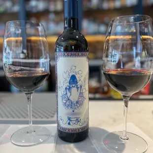 a bottle of wine and two glasses of wine