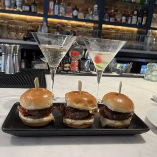 three sliders with a martini in the background