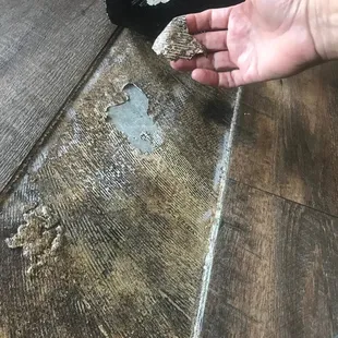 a person's hand touching a piece of wood