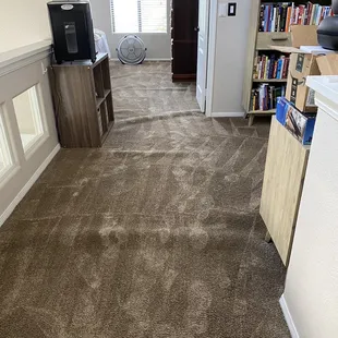 a living room with bookshelves and a television