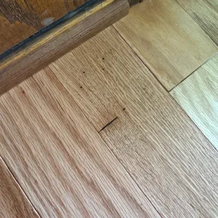 Damaged wood glued down permanently.