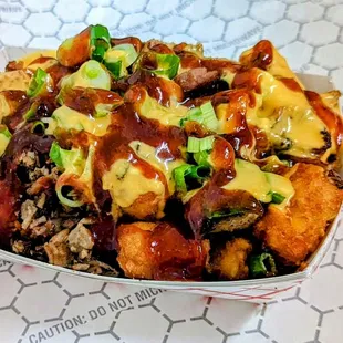 Tots with chopped Brisket, or Chopped Pork, or Beef Chili with cheese and CARR B QUE&apos;S special BBQ sauce