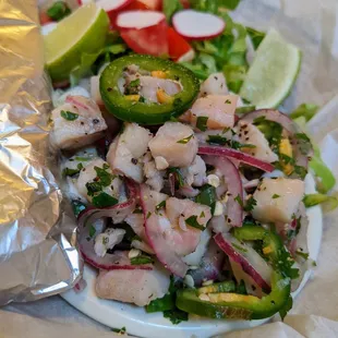 Ceviche (tilapia). $8.75. Seafood marinated in lemon, jalapenos, and cilantro, served with two warm flour tortillas.