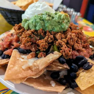 Nachos. $8.75. Black beans, guacamole (+$3.75), housemade corn and flour chips, Monterey Jack cheese, sour cream, jalapenos, salsa fresca.