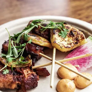 Pork belly skewers with pineapple and chipotle aioli.