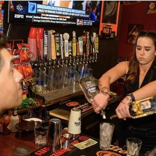 a bartender pouring a drink