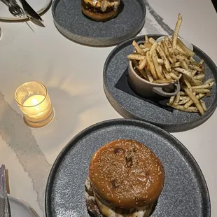 a hamburger and fries on plates