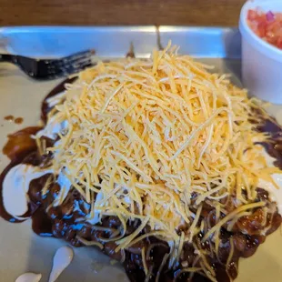 Delicious! Baked beans, pulled pork, cheese and pico! Homemade BBQ sauces! So good! Highly recommend!