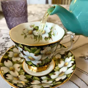 tea being poured into a teapot