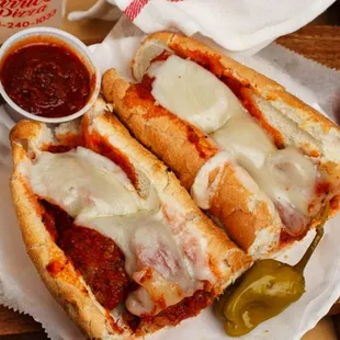 Meatball sub with meatballs, cheese and marinara sauce.