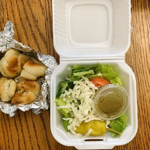 Side items: garlic knots and salad with Italian dressing