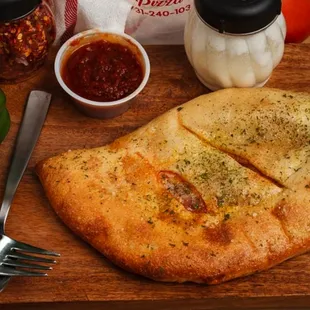 Sausage roll with sausage, peppers, onions, and mozzarella cheese.