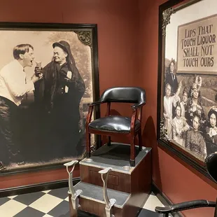 a barber chair in front of a portrait of a woman