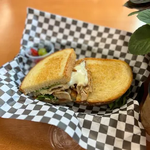 Turkey and cheese on toasted sourdough bread with spinach, onion, tomato and mayo
