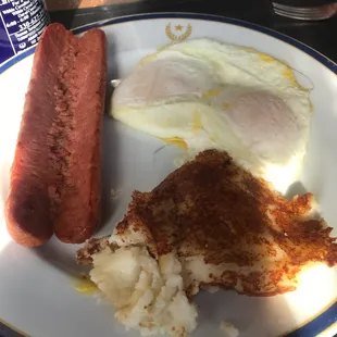 Potato cake and smoked sausage with eggs over easy