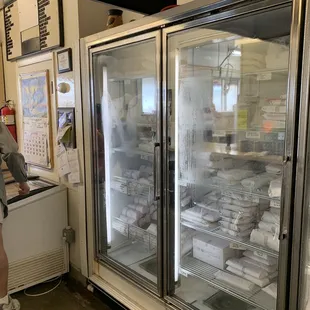 a man standing in front of a refrigerated refrigerator