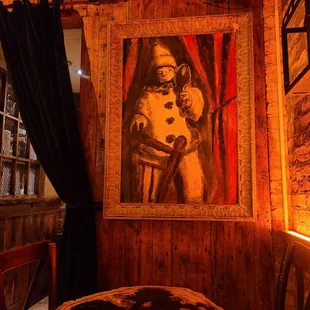 a painting of a woman on a wall above a table