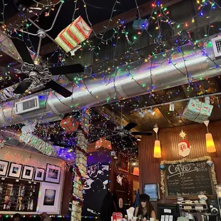 the ceiling decorated with christmas lights