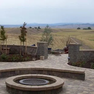 a patio with a fire pit