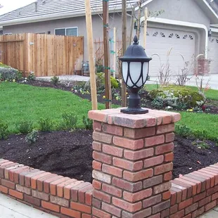 a brick wall with a lamp post