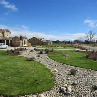a driveway with a gravel path in front of a house