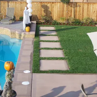 a backyard with a pool and lawn