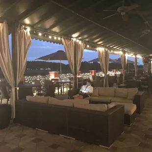 Club house patio with plenty of comfy couches and a view of the golf course at Carrollwood country club, North Tampa