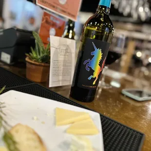 a bottle of wine and cheese