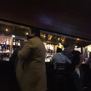 a group of people sitting at a bar