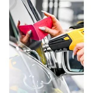 a woman's hand holding a cup of coffee