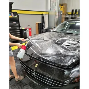 a woman waxing a car