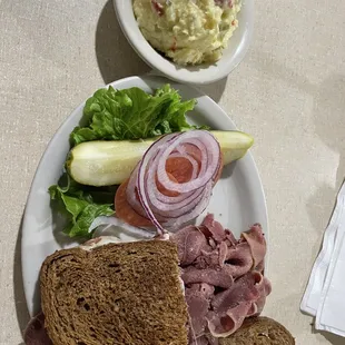 Tongue on toasted pumpernickel with provolone and potato salad.