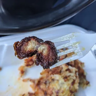 a fork holding up a piece of meat