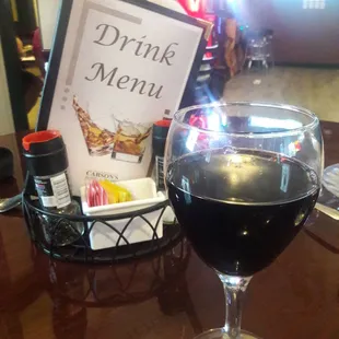 a glass of wine and a menu