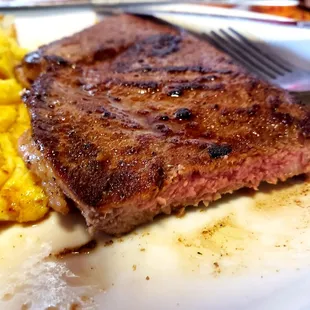 a steak and eggs on a plate